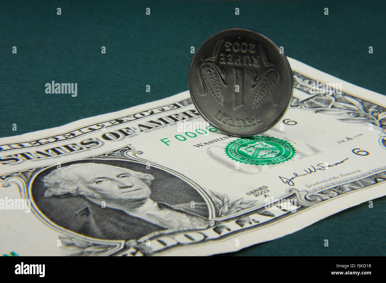 Indian Rupee coin and American Dollar note Stock Photo