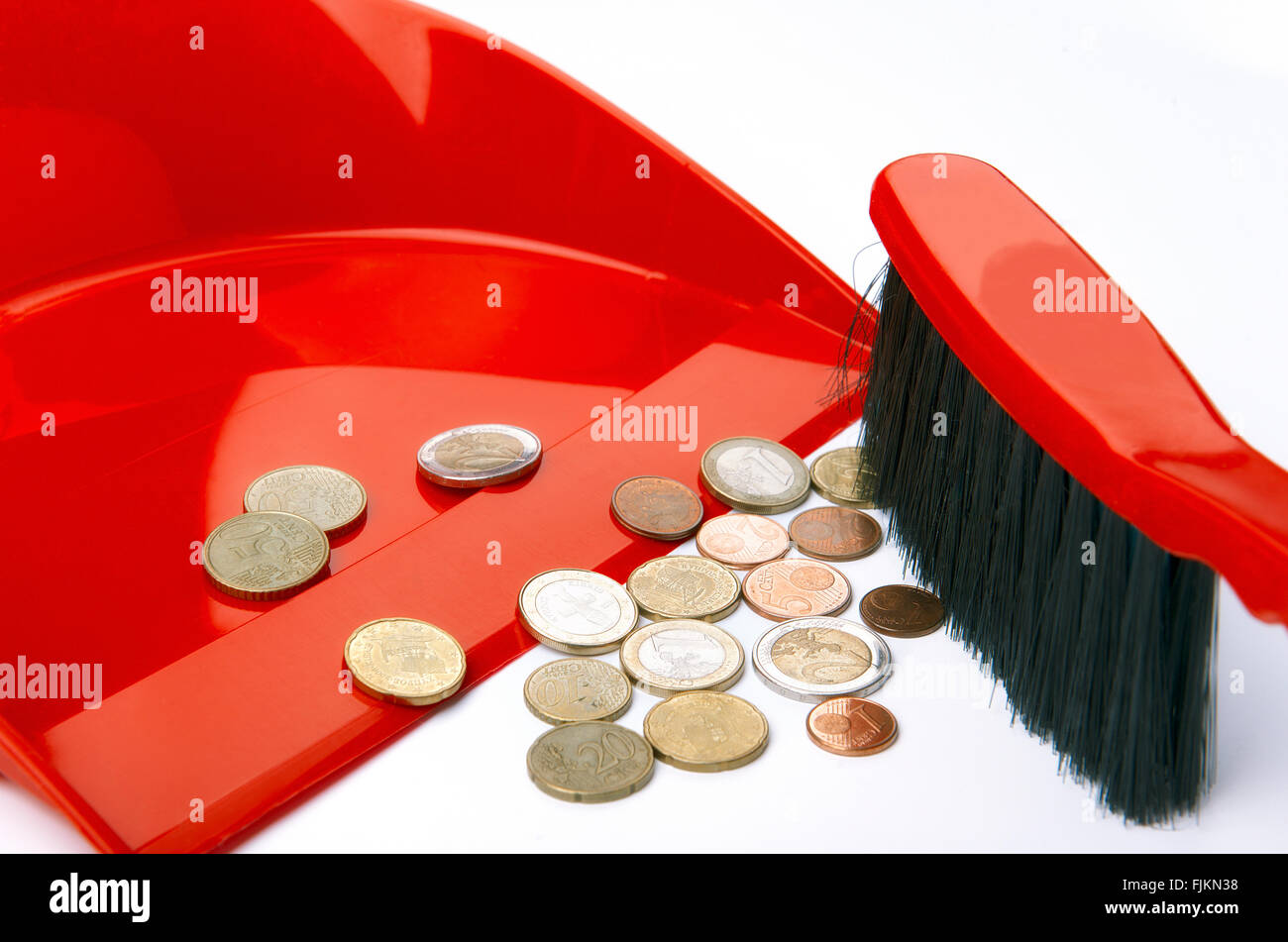 Dustpan, brush and eurocent Stock Photo