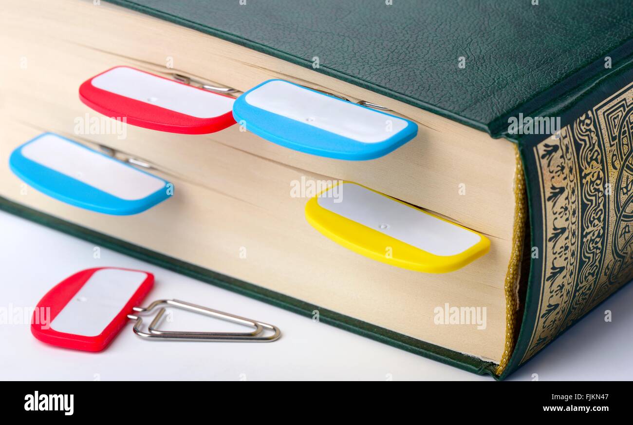 Staples with signs on a section of the book, close up, shallow DOF Stock Photo