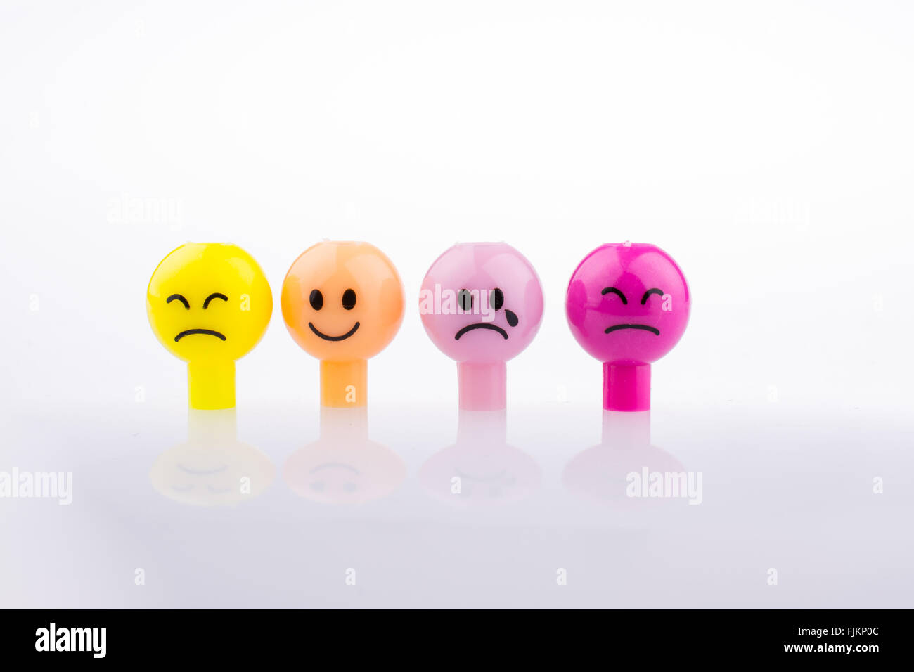 Color beads with facial expression on white background Stock Photo
