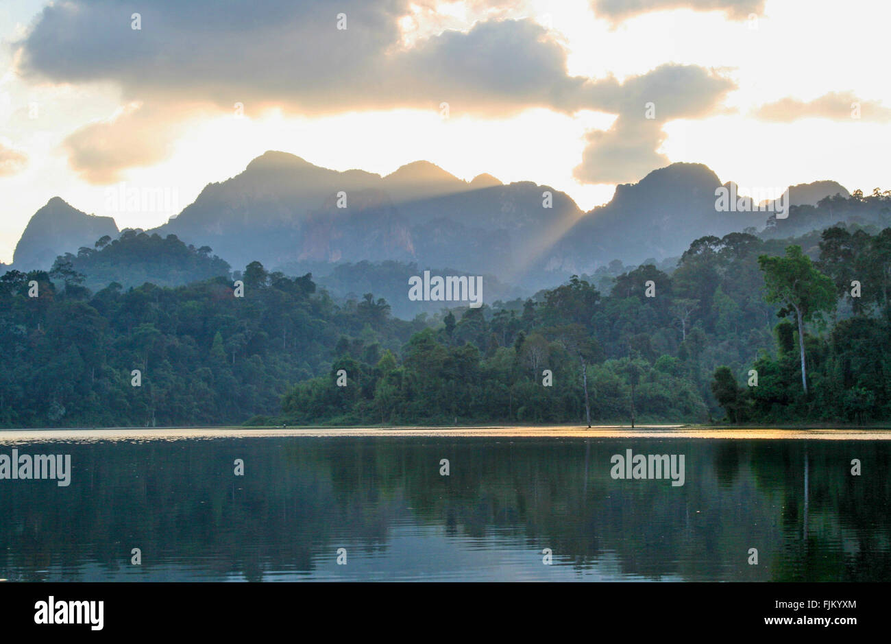 Sunset over mountains at Cheow Larn Lake, from Rainforest Camp, Elephant Hills, Khao Sok National Park, southernThailand Stock Photo