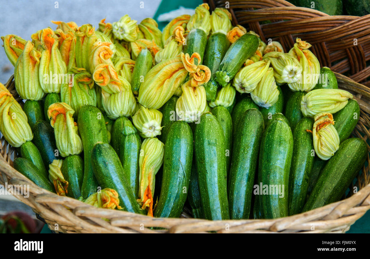 Courgette flowers in a basket, market stall in Otranto, Puglia, southern Italy Stock Photo