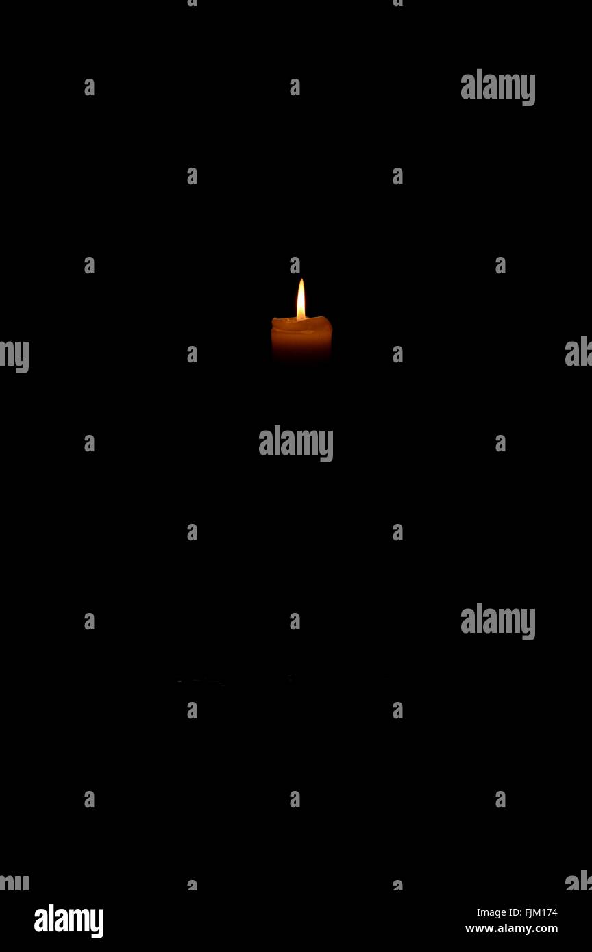 Single candle on a black background Stock Photo - Alamy