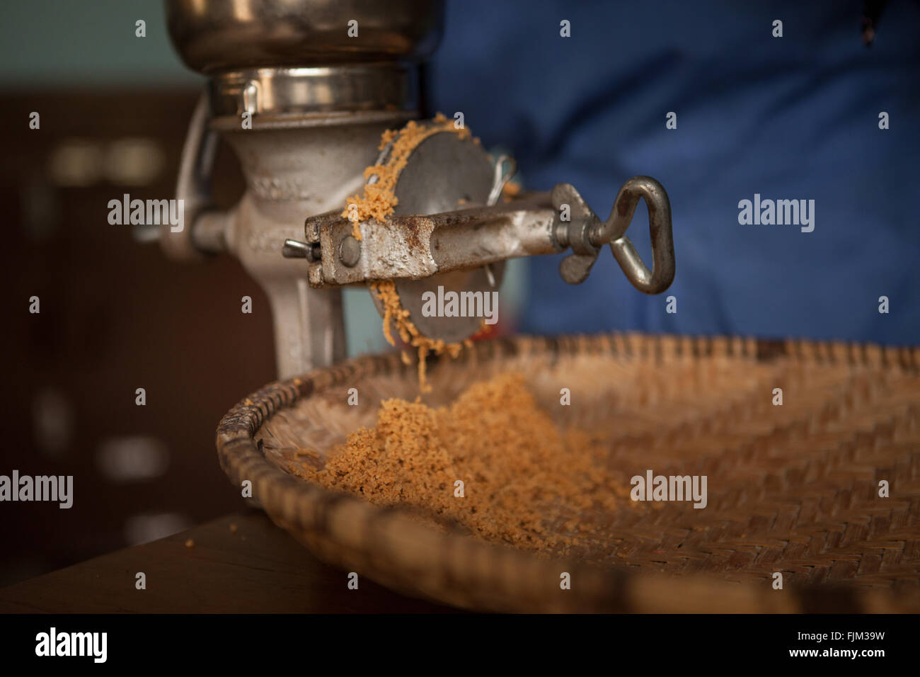 A business woman grinding peanuts to sell, Tanzania Stock Photo