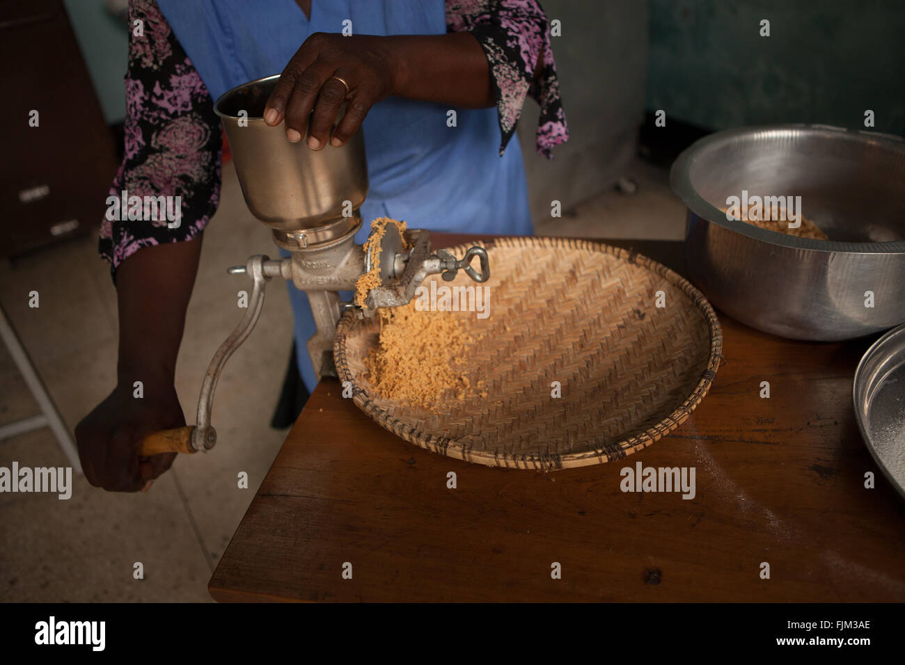 A business woman grinding peanuts to sell, Tanzania Stock Photo