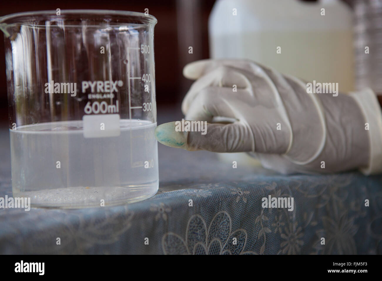 Water being measured in a jug ready for homemade soap making Tanzania. Stock Photo