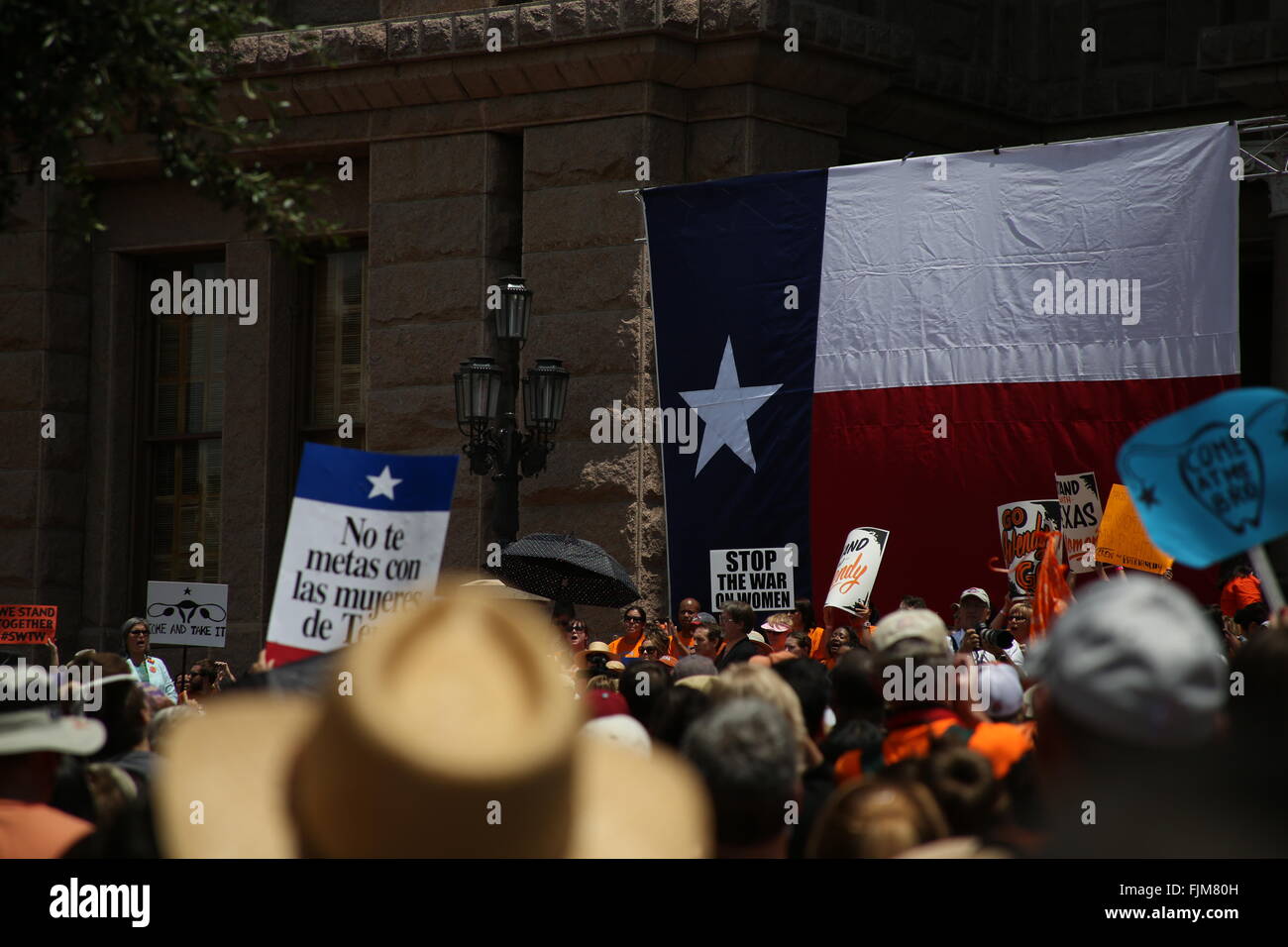 A crowd gathers outside the Texas state capital to hear Wendy Davis speak against abortion clinic legislation Stock Photo