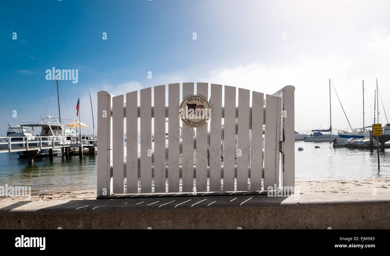 white picket fence gate with 'no trespassing' Stock Photo