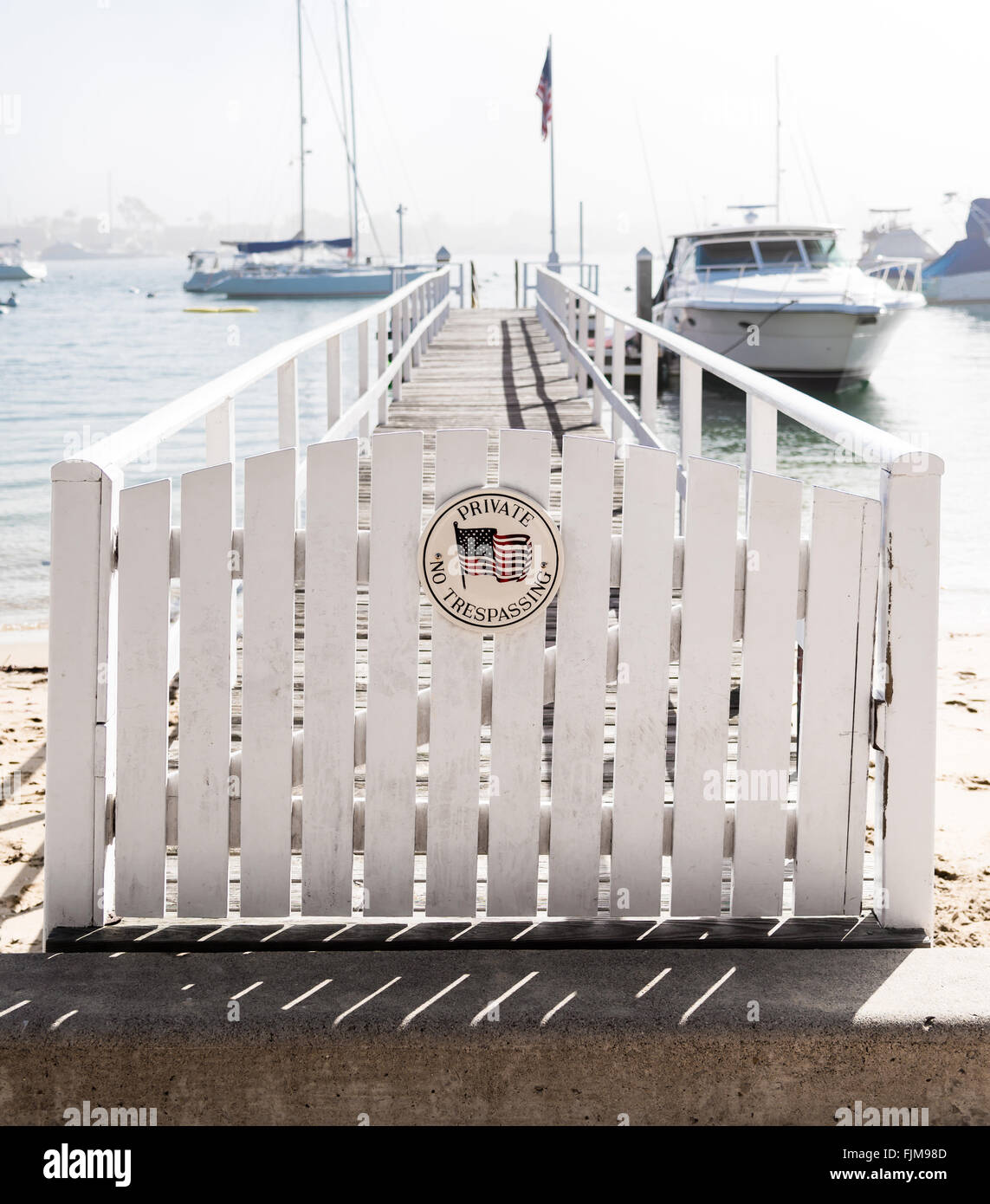 white picket fence gate with 'no trespassing' Stock Photo