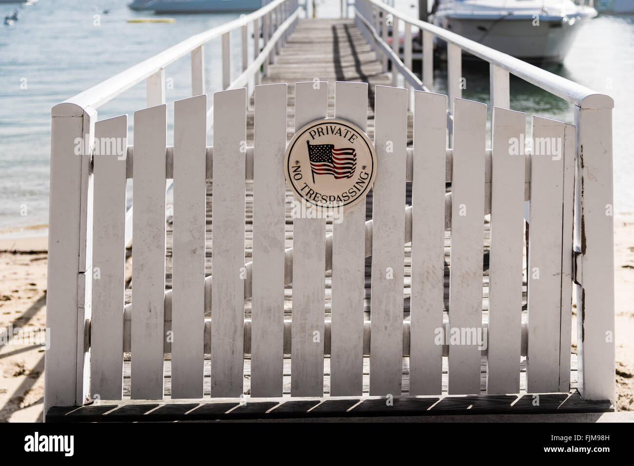 white picket fence gate with 'no trespassing' Stock Photo