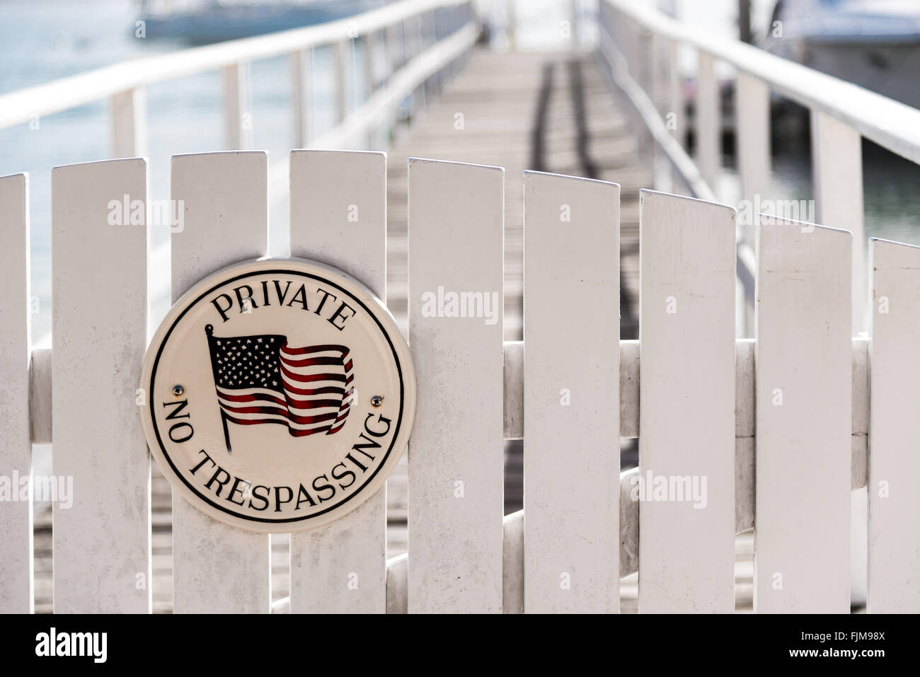 white picket fence gate with 'no trespassing' Stock Photo