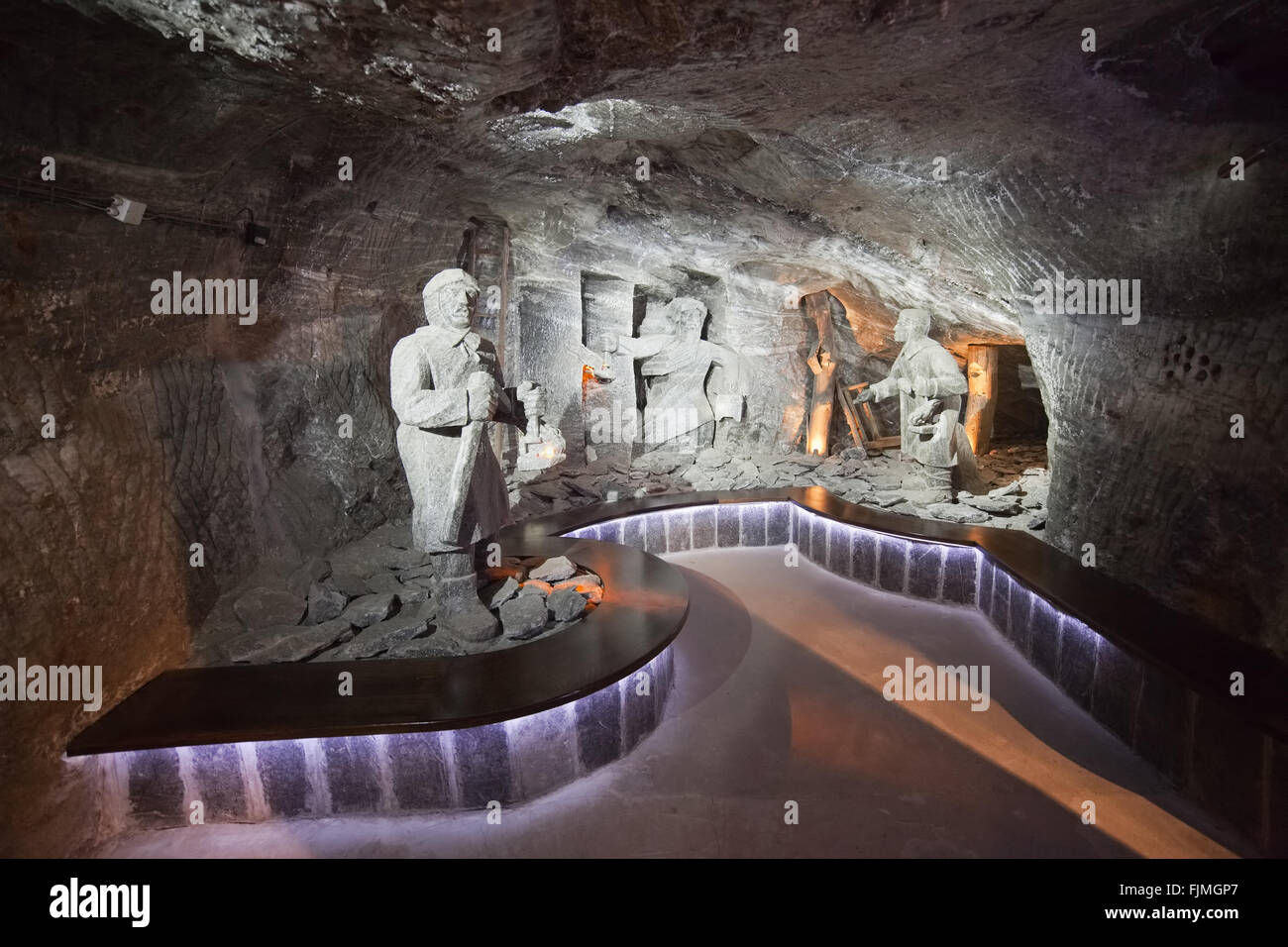 Europe, Poland, Wieliczka Salt Mine, salt rock sculptures of miners and curved bench Stock Photo