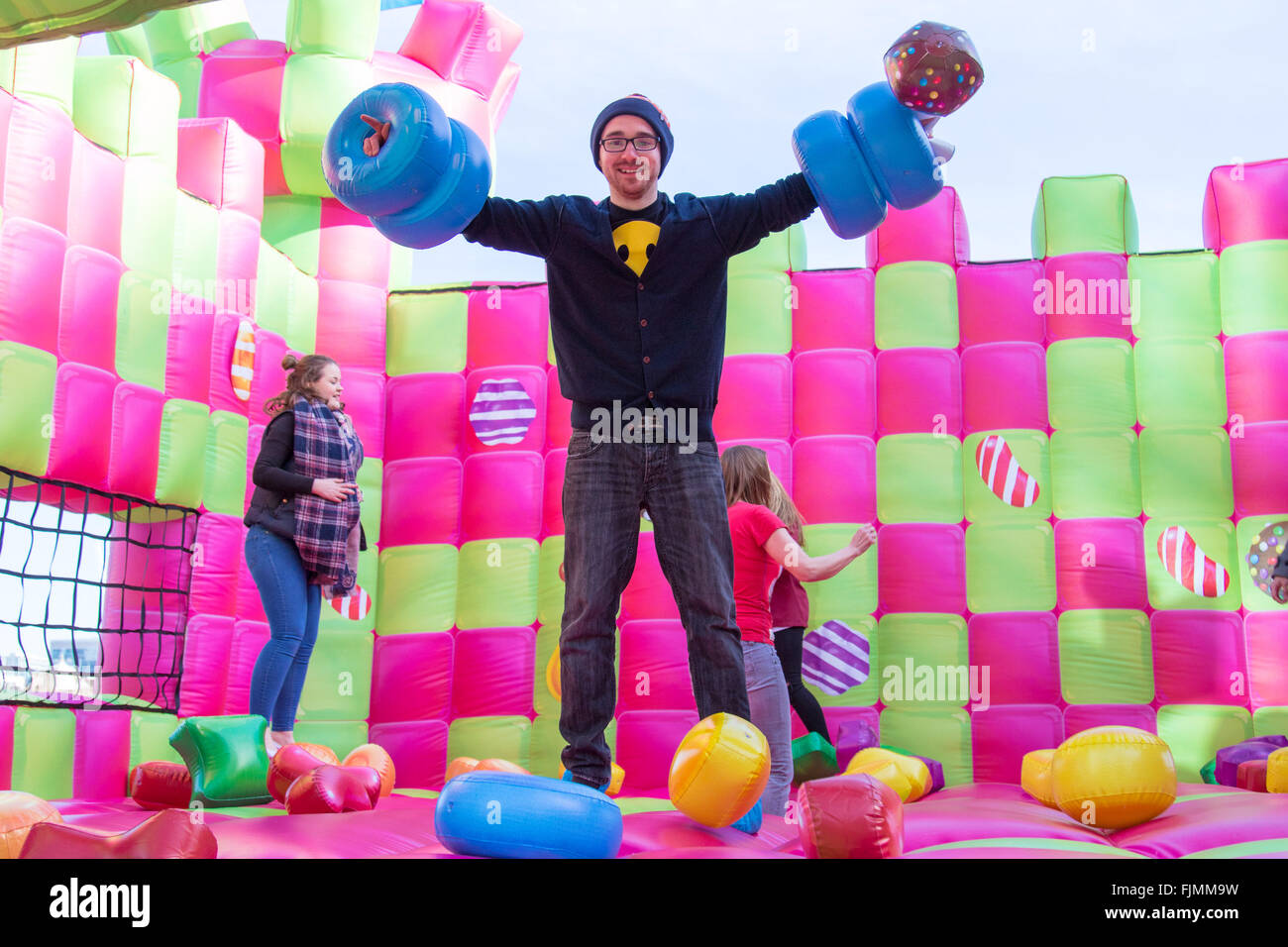 More London Place, London, UK. March 3rd 2016. A jelly-themed, adults-only bouncy castle which has been created to celebrate the launch of Candy Crush Jelly Saga, opens on London’s Southbank. The multi-sensory bouncy castle especially designed for grown-ups,  marks the latest instalment of the new mobile game, Candy Crush Jelly Saga. The bouncy castle brings to life elements of the jelly-themed game and will be open to the public for free. Credit:  Paul Davey/Alamy Live News Stock Photo