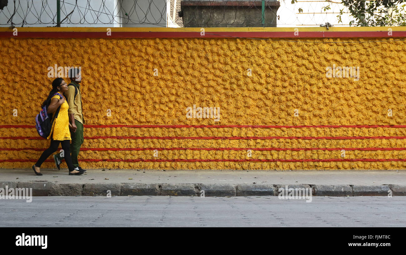 India, 19 February 2016. Students Walk past Colorful Wall in Kolkata. Photo by Palash Khan Stock Photo