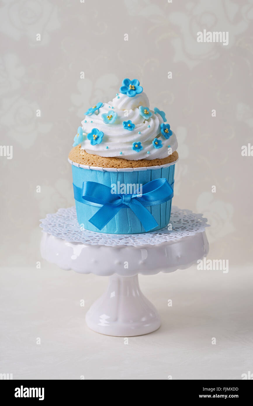 Cupcake with blue forgetmenot flowers Stock Photo