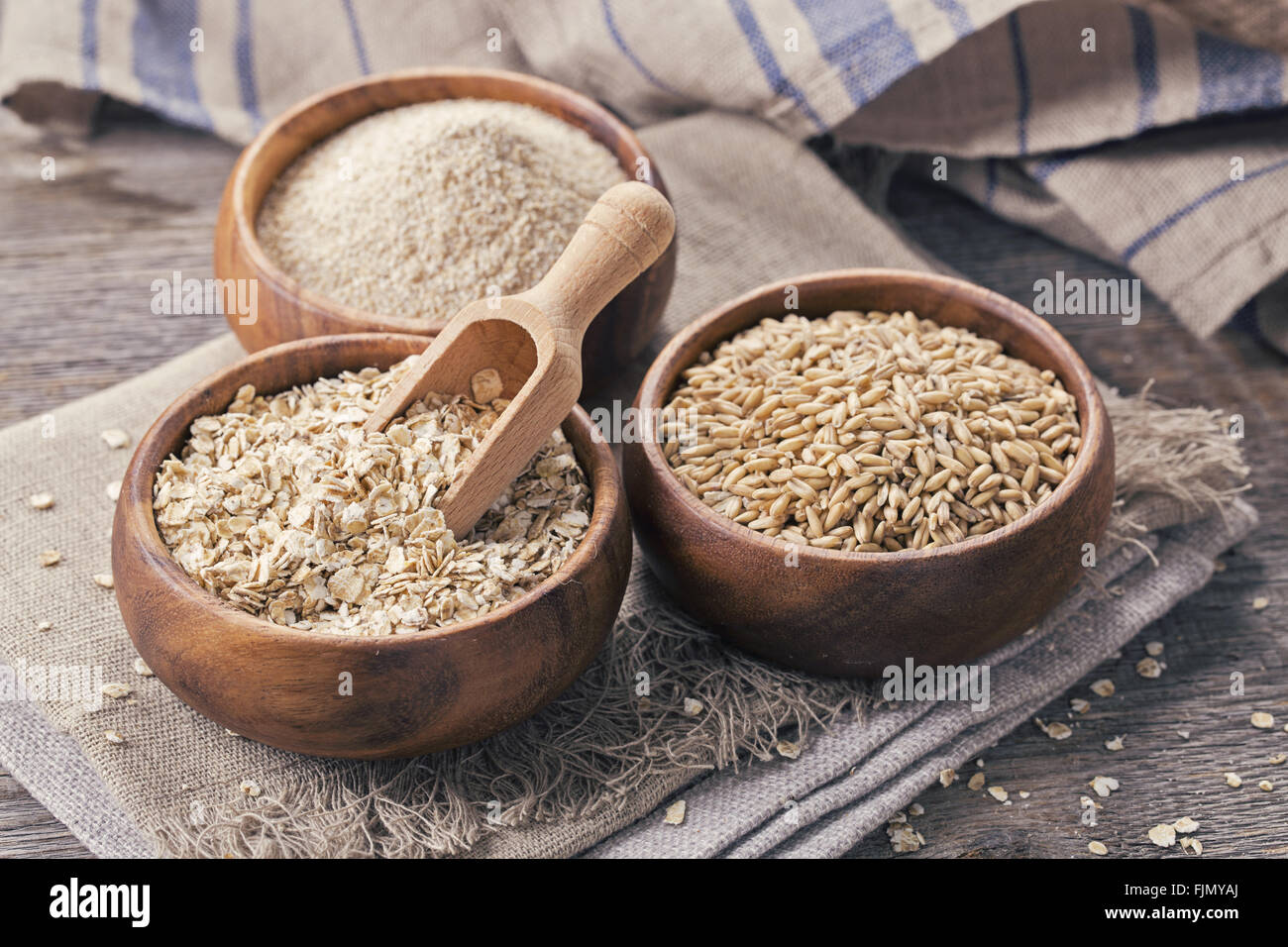Oat flakes, seeds and bran in bowls Stock Photo