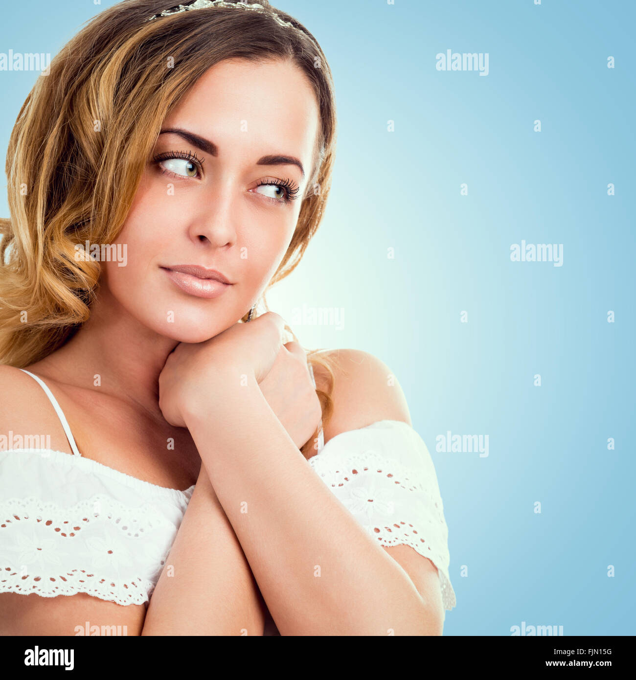 Portrait of a beautiful young woman on a blue background Stock Photo