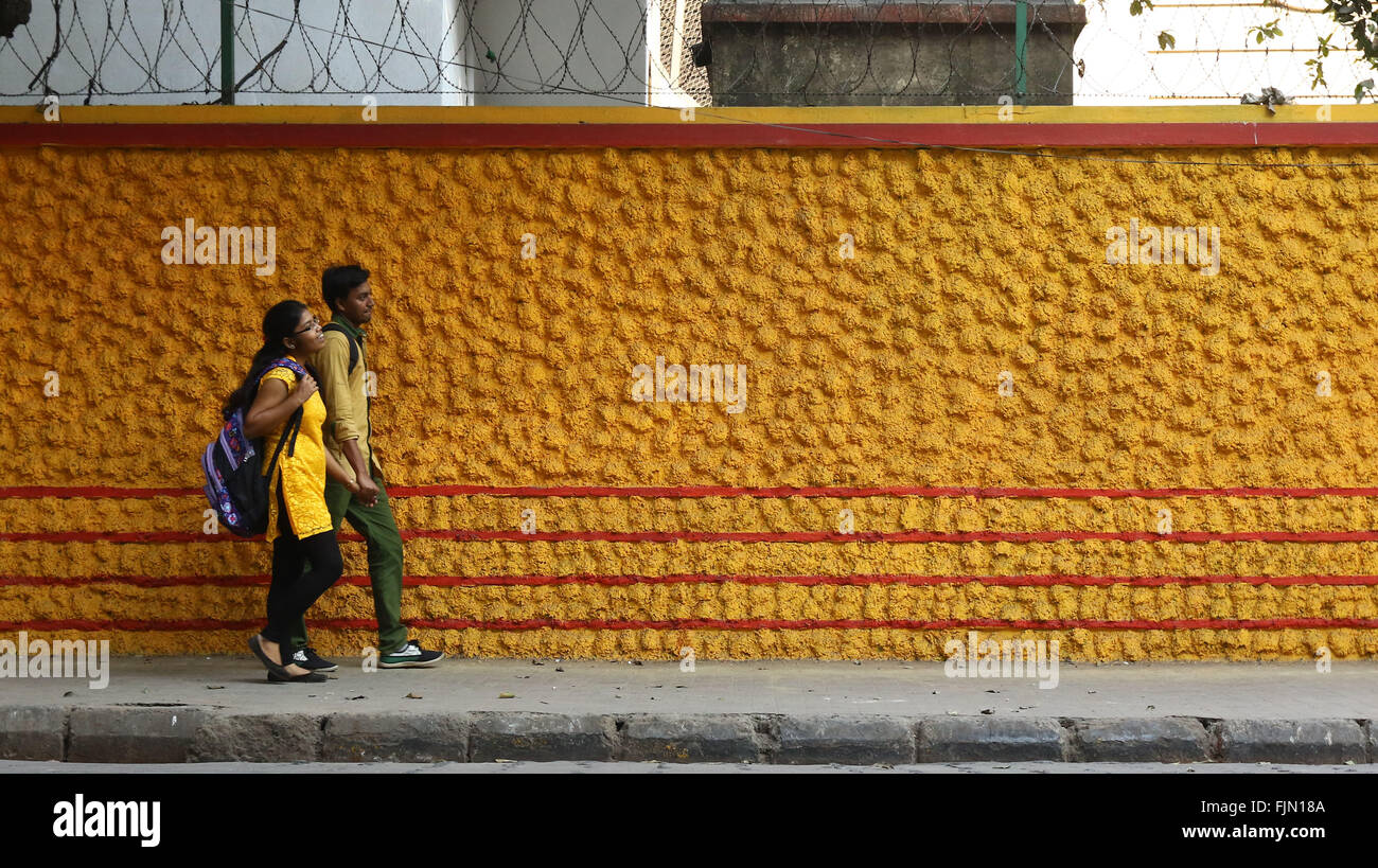 India, 19 February 2016. Students Walk past Colorful Wall in Kolkata. Photo by Palash Khan Stock Photo