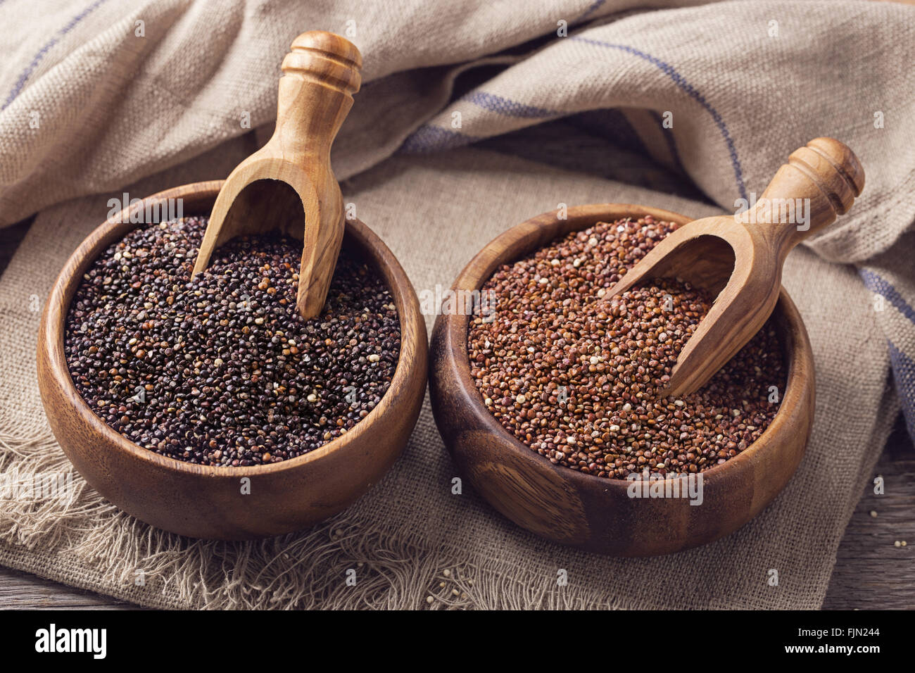 Red, black quinoa seeds on a wooden background Stock Photo