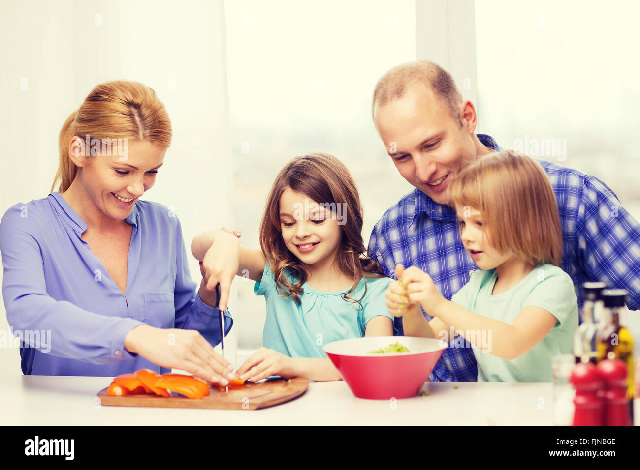 happy family with two kids making dinner at home Stock Photo - Alamy