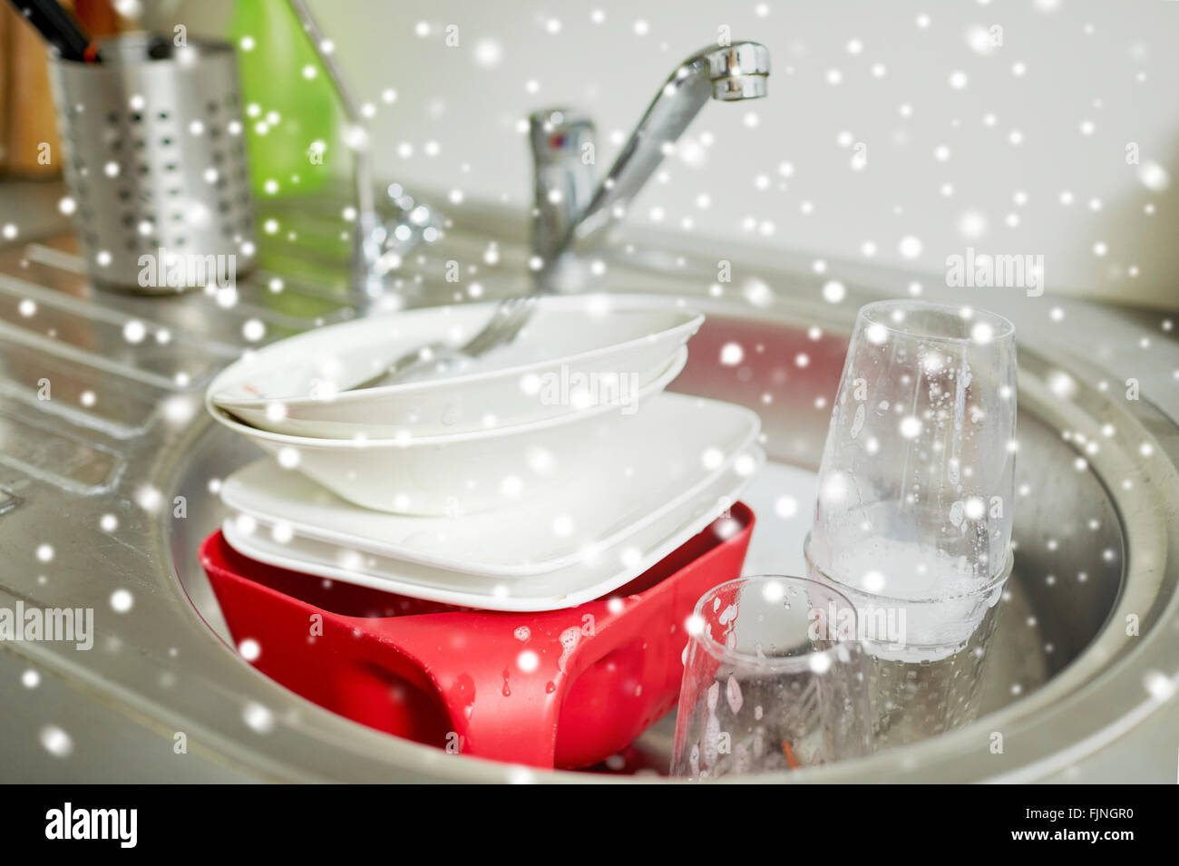 close up of dirty dishes washing in kitchen sink Stock Photo