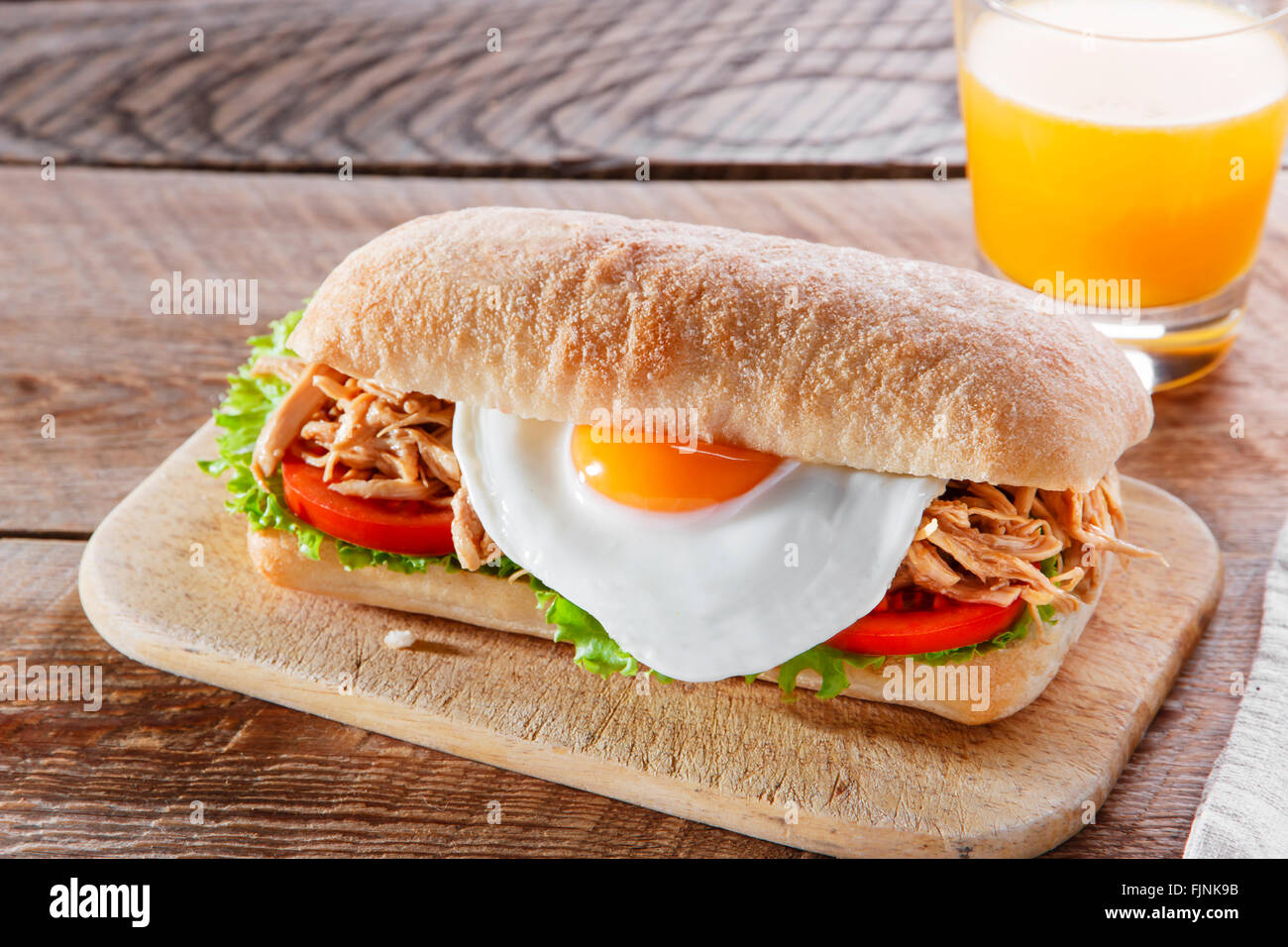 Sandwich with grilled meat egg tomato salad ciabatta Stock Photo Alamy