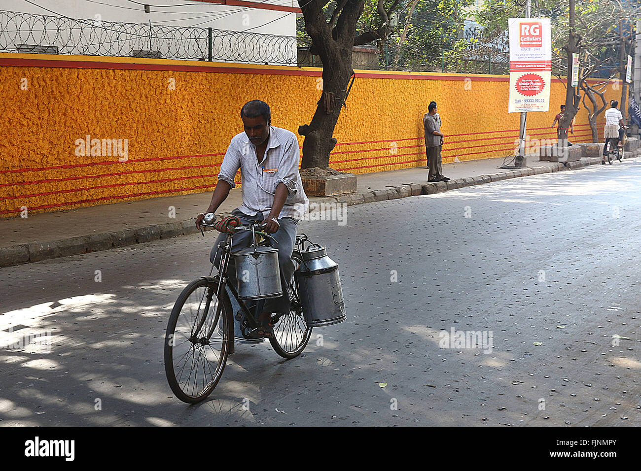 India, 18 February 2016. An Indian men carrying milk in metal canisters on both sides of their 22 inch bicycles in Kolkata. Phot Stock Photo