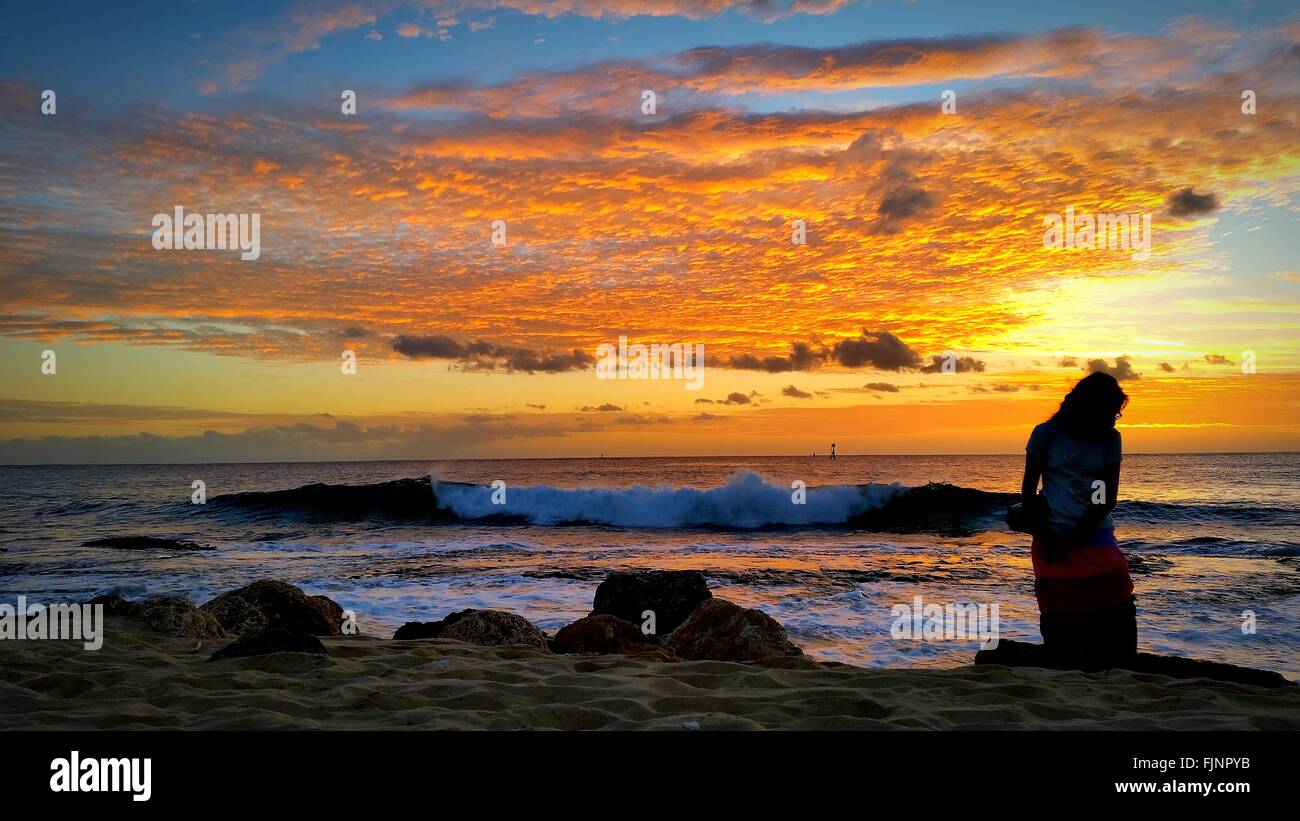 Woman kneeling sand beach sunset beach hi-res stock photography and ...