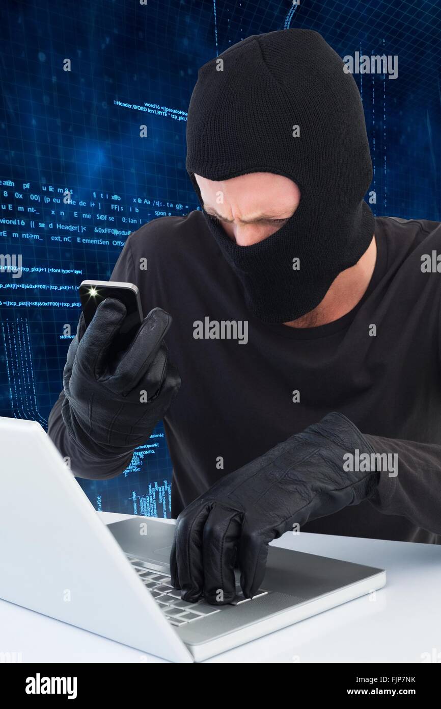 Thief taking picture document on laptop Stock Photo - Alamy