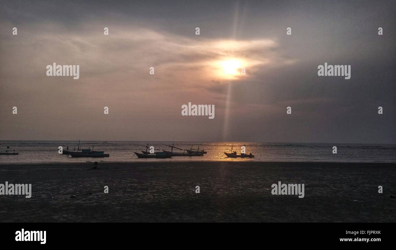 Silhouette Boats On Sea At Beach During Sunset Stock Photo - Alamy