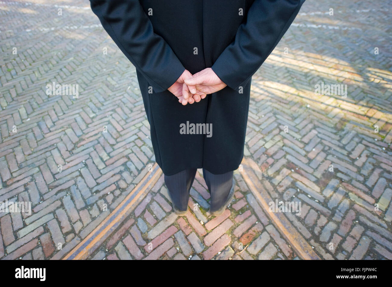 A funeral leader is waiting on a cemetery Stock Photo
