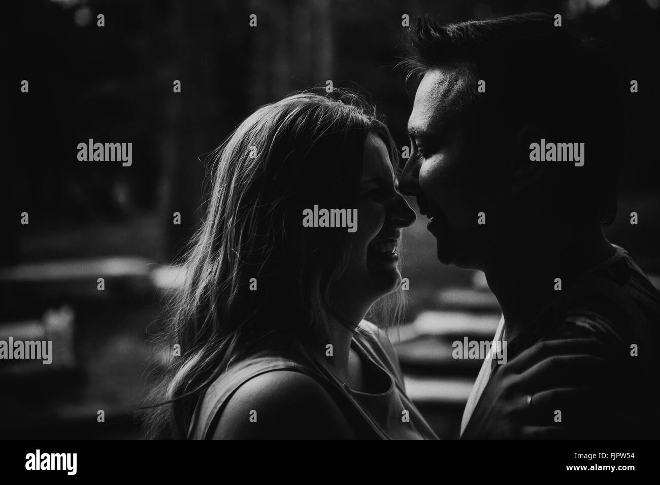 Romantic black and white photo young couple kissing on background ...