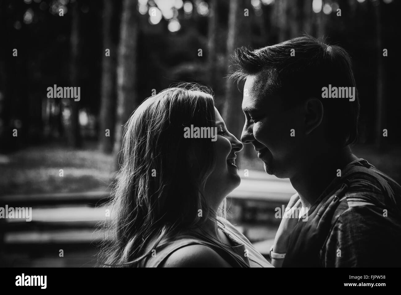 Black white photography romantic young couple kissing on background ...