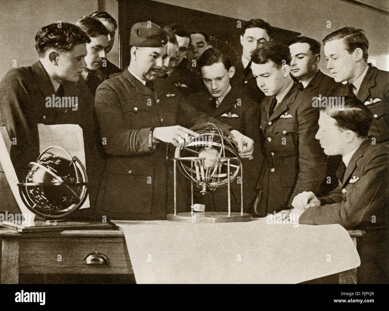 Air cadets ,c.  1940. WWII  at an air force training camp. Learning navigation and practical meteorology with spherioscopes. Stock Photo