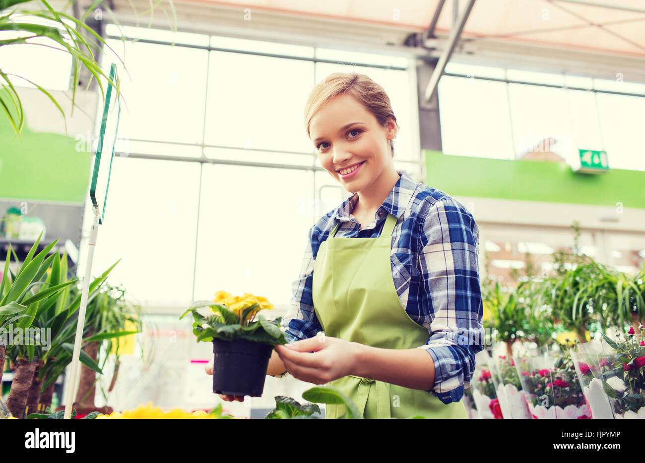 happy woman holding flowers in greenhouse Stock Photo - Alamy