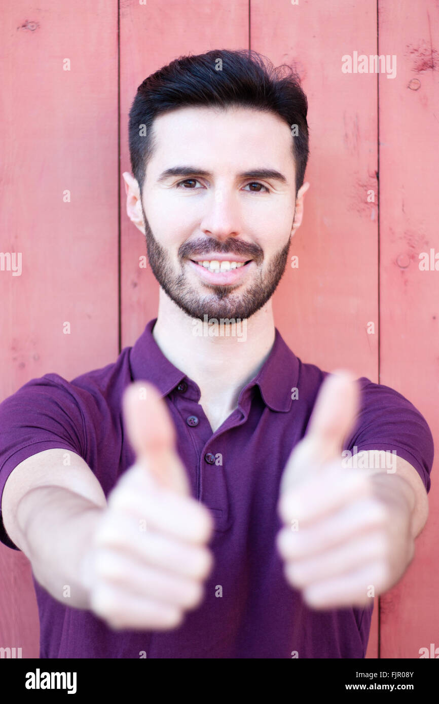 Attractive young man showing thumbs up Stock Photo