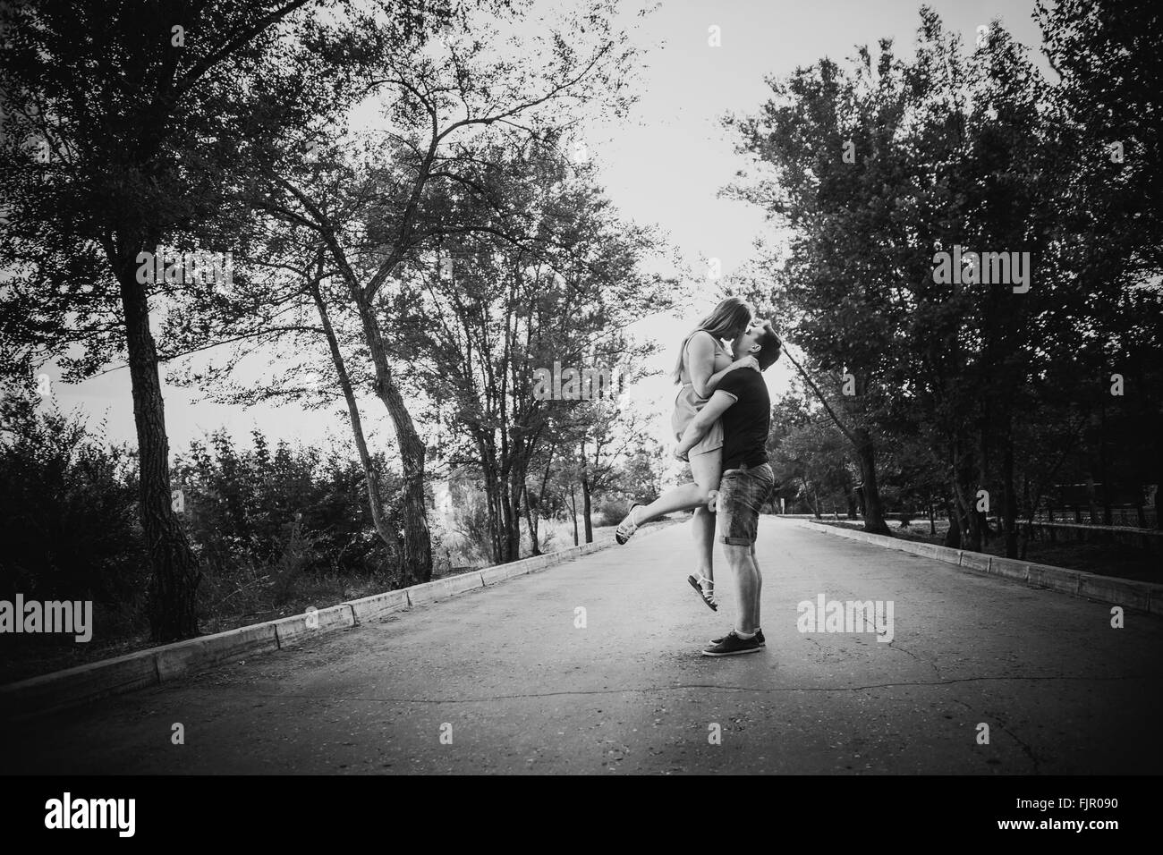 Black white photography romantic young couple kissing on background ...