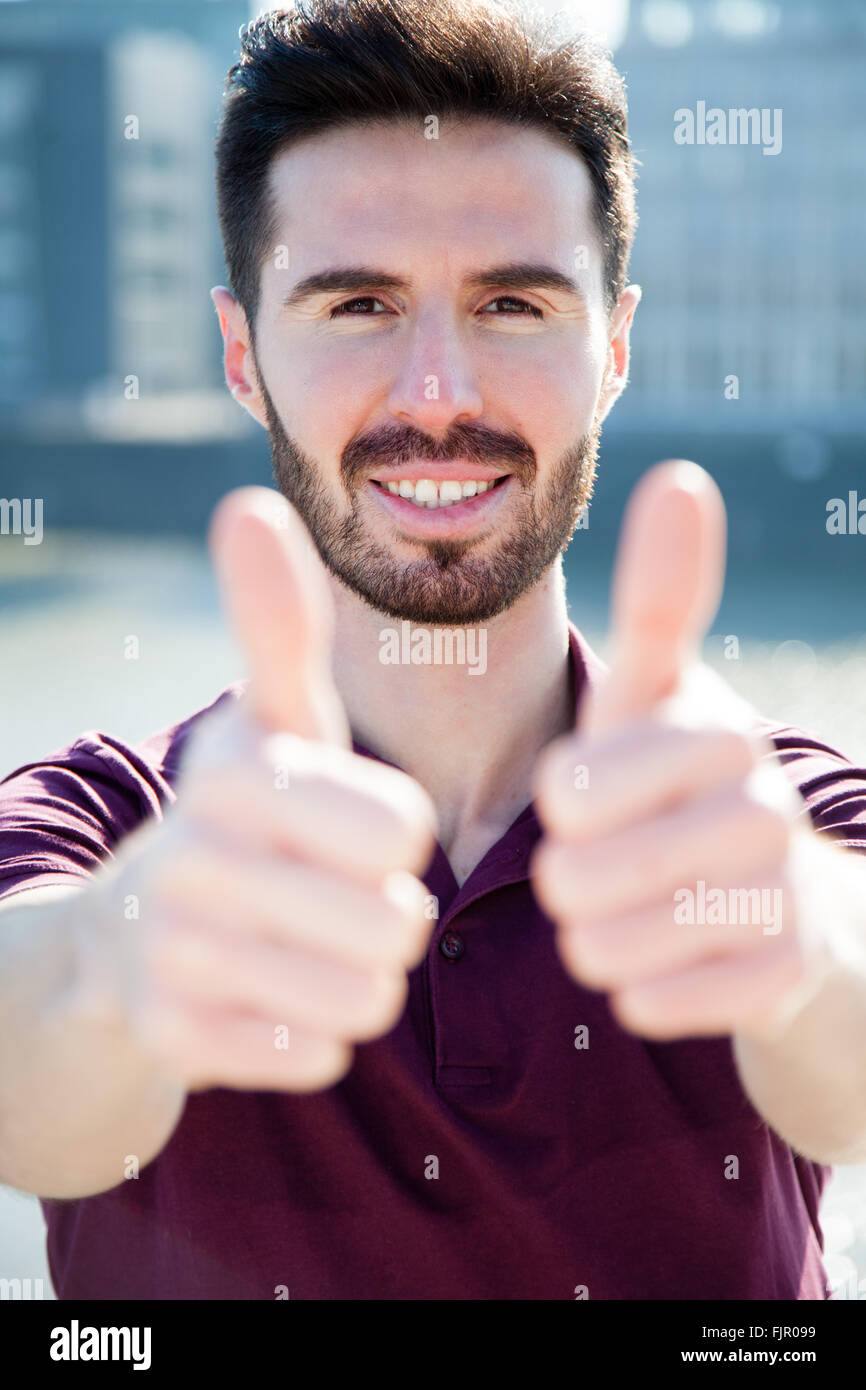 Attractive young man showing thumbs up Stock Photo