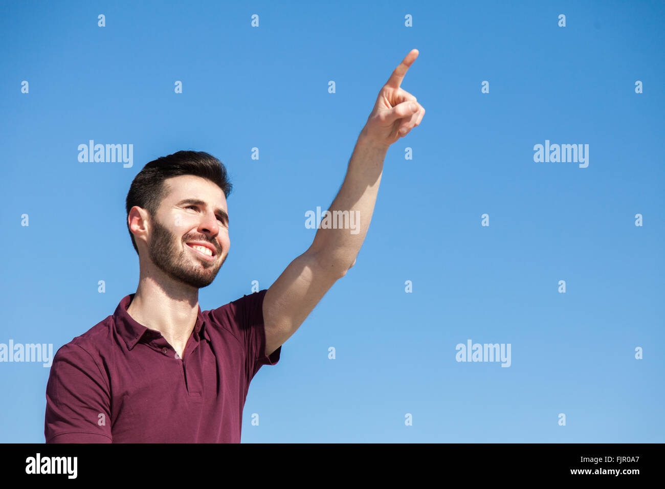 Attractive young man pointing with finger Stock Photo