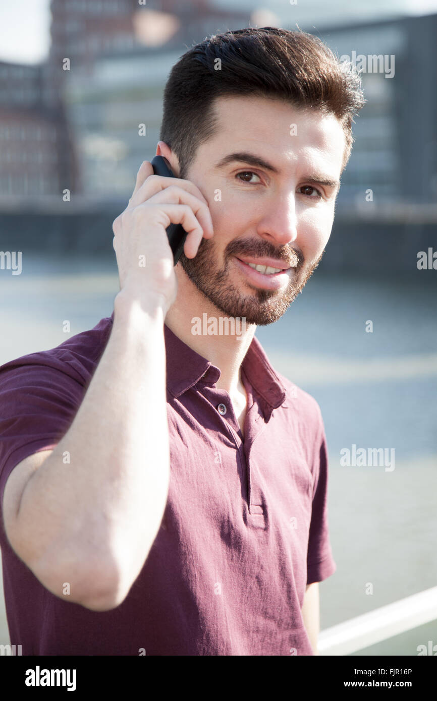 Attractive young man using smart phone Stock Photo