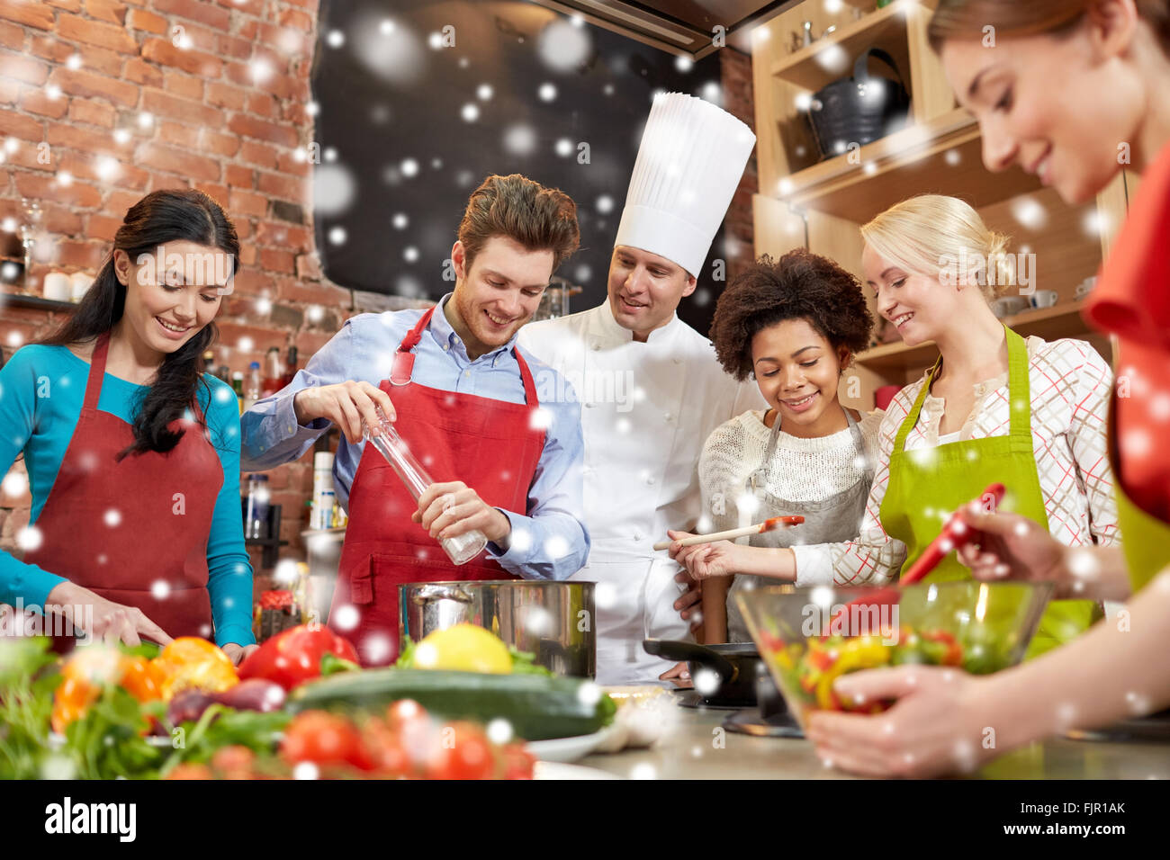 happy friends and chef cook cooking in kitchen Stock Photo - Alamy
