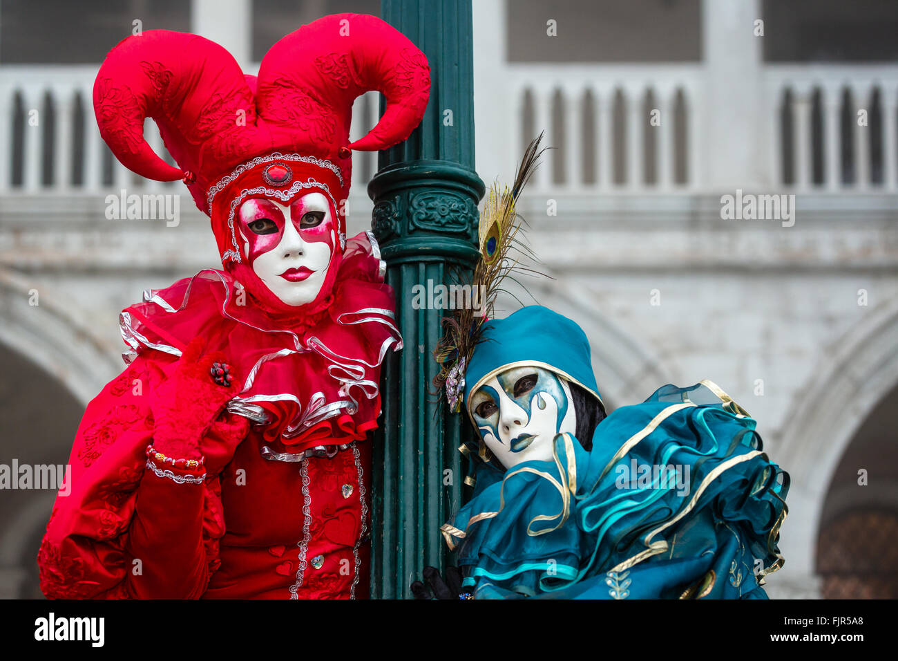 Harlequins, two women dressed up for carnival, Venice, Italy Stock Photo