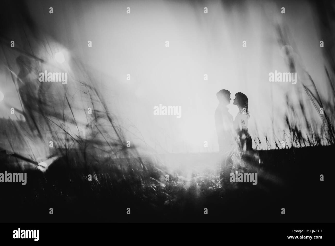 Black white photography romantic silhouette couple standing and kissing ...