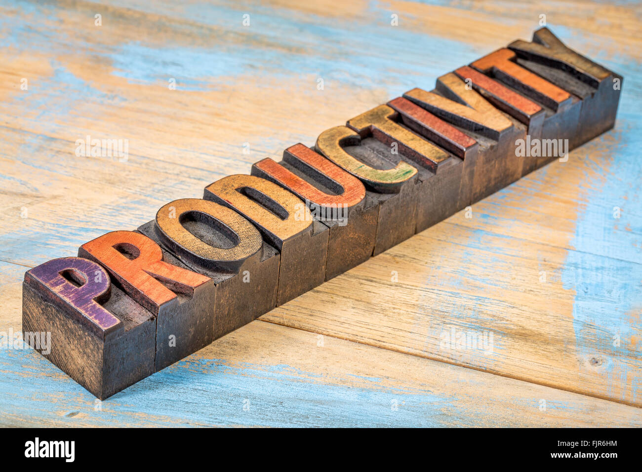 productivity word  - text in vintage letterpress wood type against grunge painted wood Stock Photo