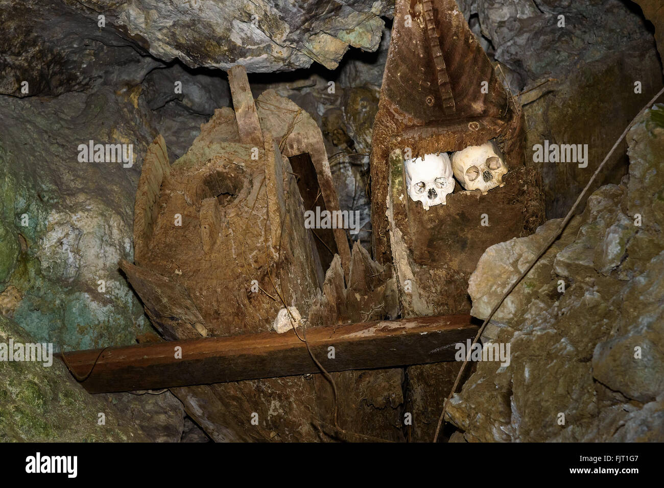 Wooden old coffins with skulls in Tampang Allo burial cave of the royal family.  Tana Toraja. South Sulawesi. Indonesia Stock Photo