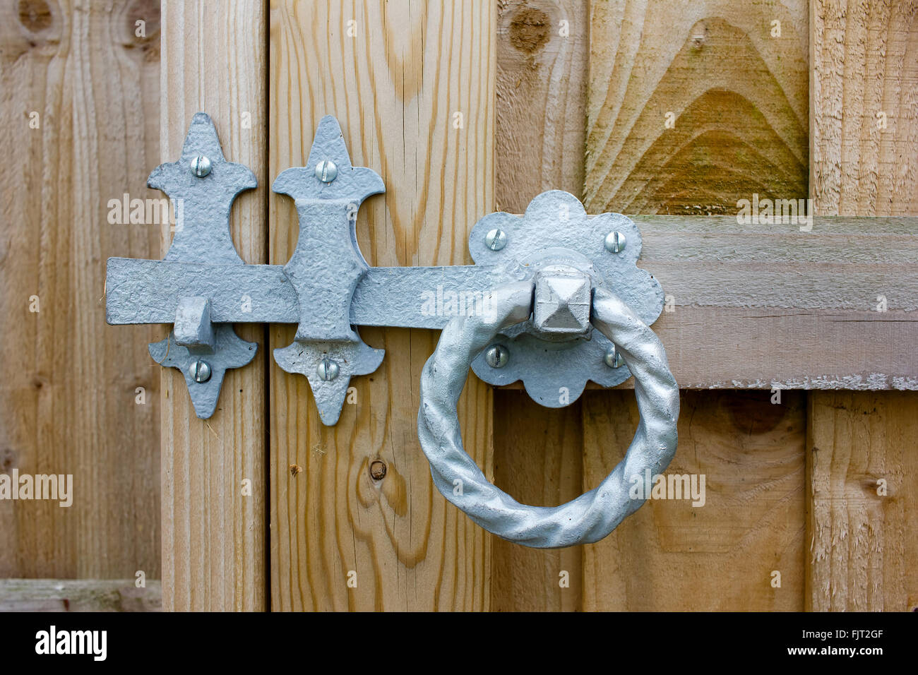 Metal Ring Latch For Garden Gate or other wood.  Round Twisted Metal Handle. Stock Photo