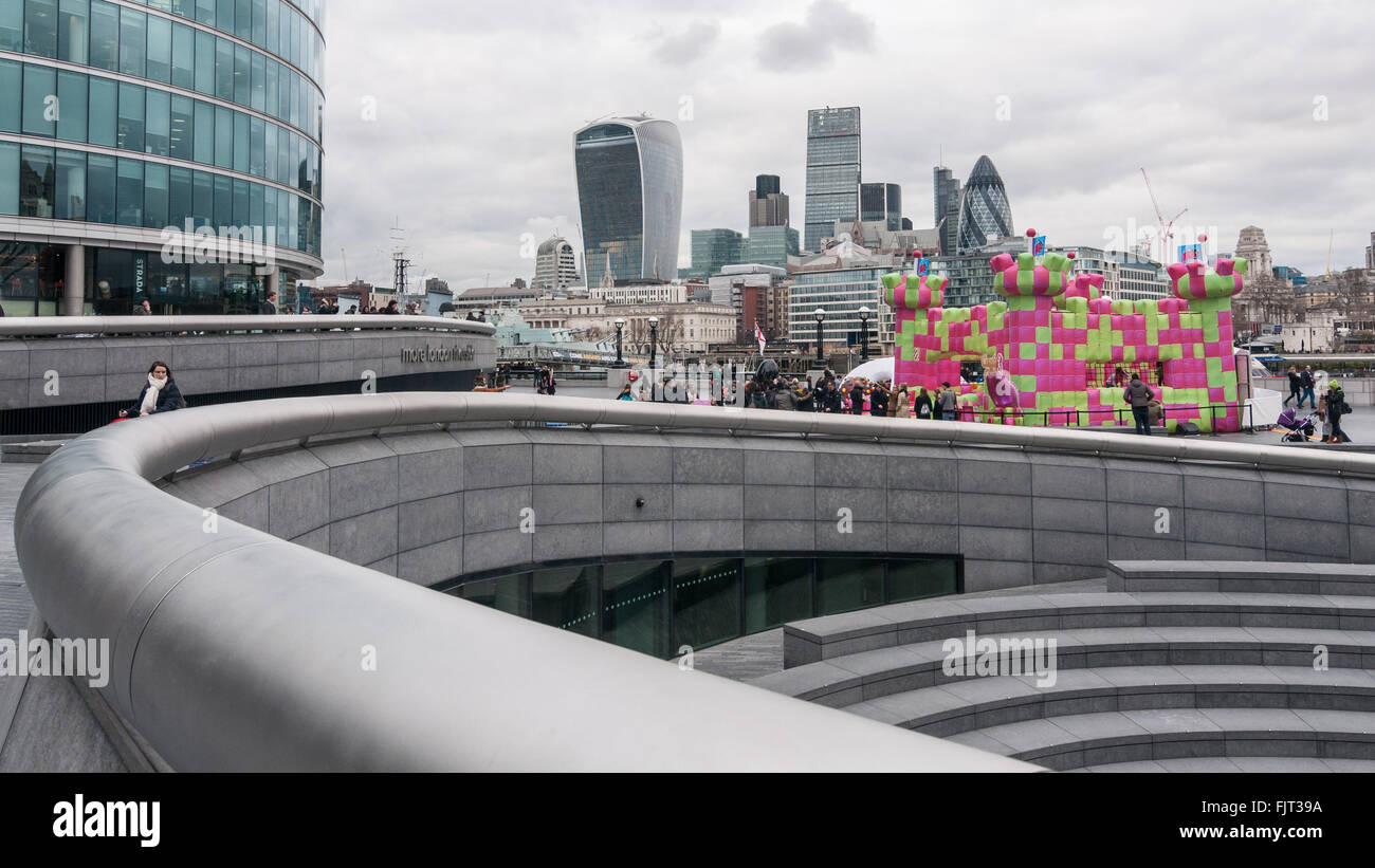 London, UK.  3 March 2016.  Members of the public enjoy playing on a jelly-themed bouncy castle erected outside City Hall at More London.  Open to adults only, the three day event celebrates the launch of a new mobile-phone game called 'Candy Crush Jelly Saga'. Credit:  Stephen Chung / Alamy Live News Stock Photo