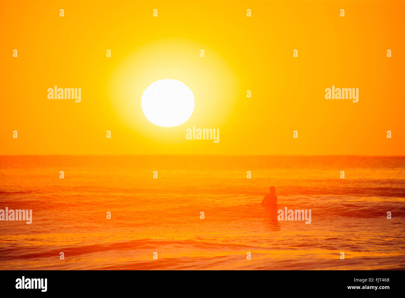 Silhouette Man In Sea Against Sunset Sky Stock Photo - Alamy