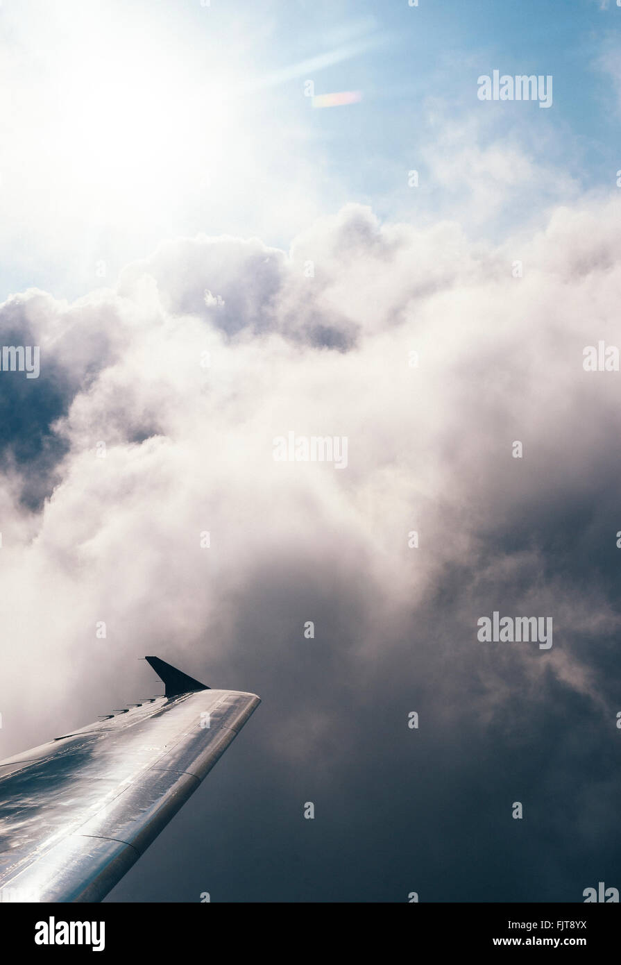 Cropped Image Of Airplane Wing In Cloudy Sky Stock Photo - Alamy