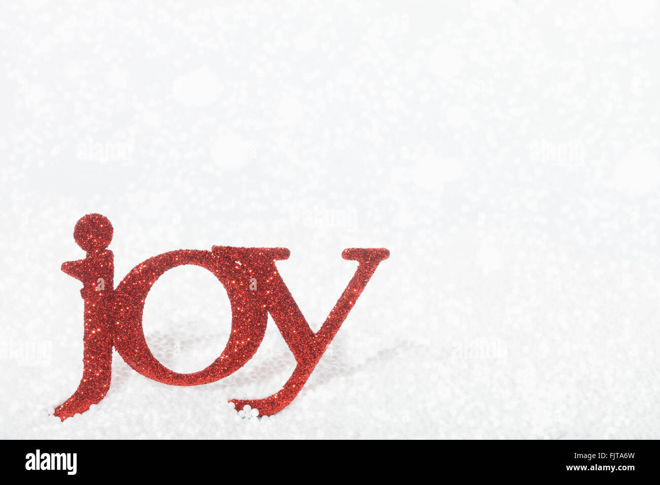 Christmas decoration - the word Joy in fake snow Stock Photo